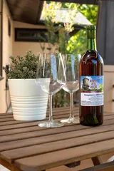 Local Texas wine and two glasses on the patio table