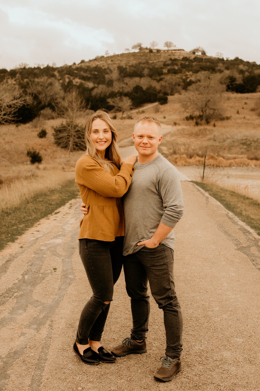 Chase Johnson, founder of CK Johnson Management, with his wife on a country road in the Texas Hill Country near San Antonio