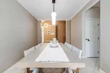 Long dining table set for ten with a modern pendant light