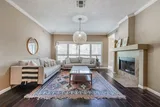 Living room with fireplace, sofa seating, and hardwood floors